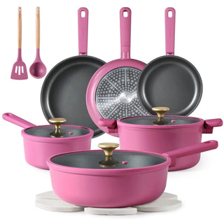 Modern kitchen cookware set including non-stick pots, frying pans, lids, and utensils on a stovetop and counter